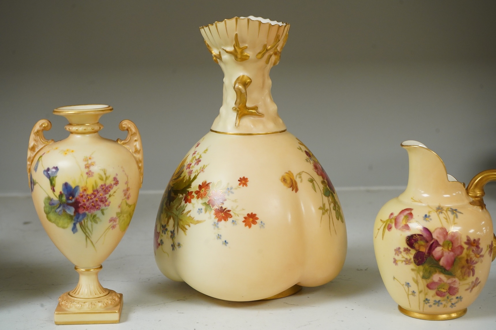 Three pieces of Royal Worcester blush ivory porcelain vessels, tallest 20cm